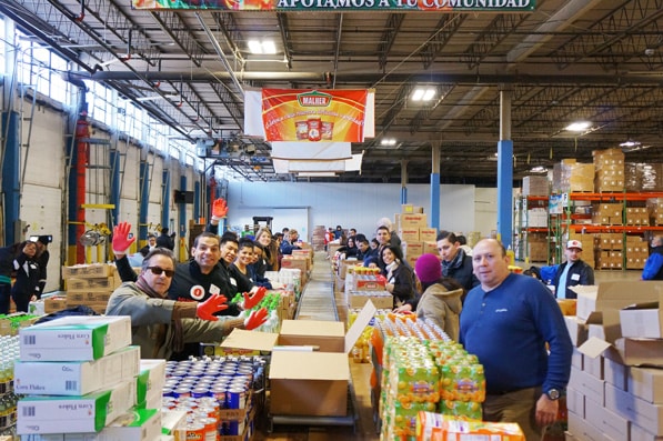 Workers prepare packages for the Bags of Love program. Since 2009, the donations have helped more than 3,700 families with a total investment of approximately $500,000.