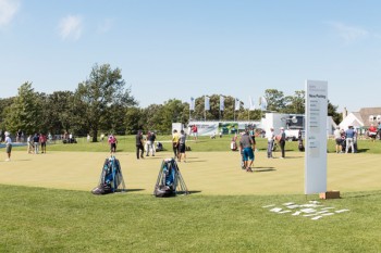 Pro golfers, including Championship winner Jason Day, practice on the BMW Experience Center putting green 