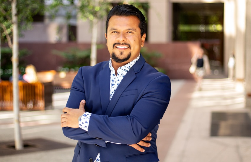 Luis Madrigal, Uber, wide portrait, courtyard in background