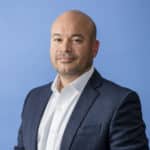 Ricardo Madan, TEKsystems, portrait blue background