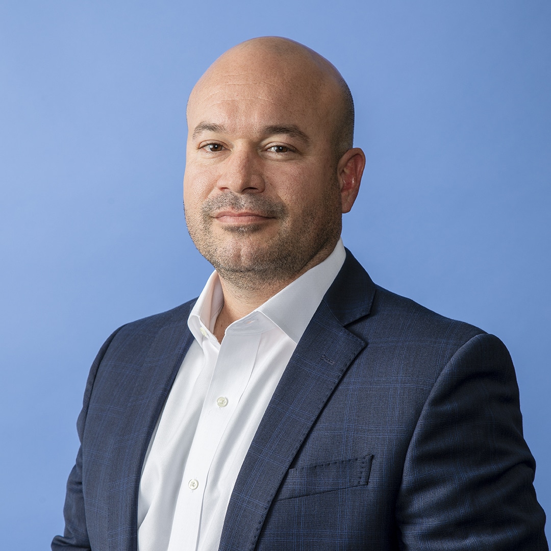 Ricardo Madan, TEKsystems, portrait blue background