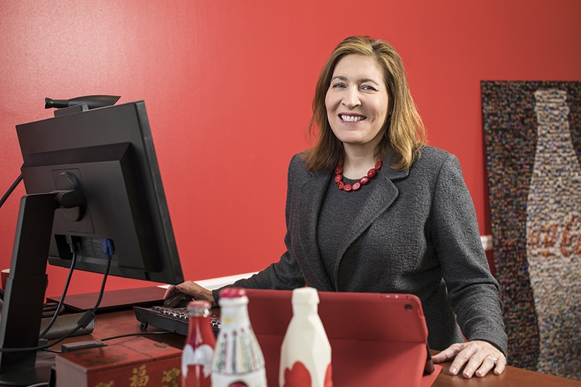 Beatriz Perez, SVP, Coca-Cola, at desk red background