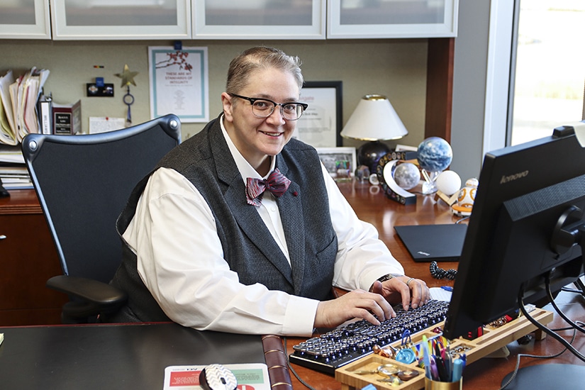 La Dell Diaz, SVP of Legal, ACI Worldwide - portrait at desk