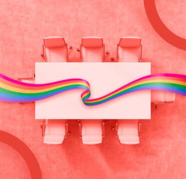 boardroom table and LGBTQ+ flag