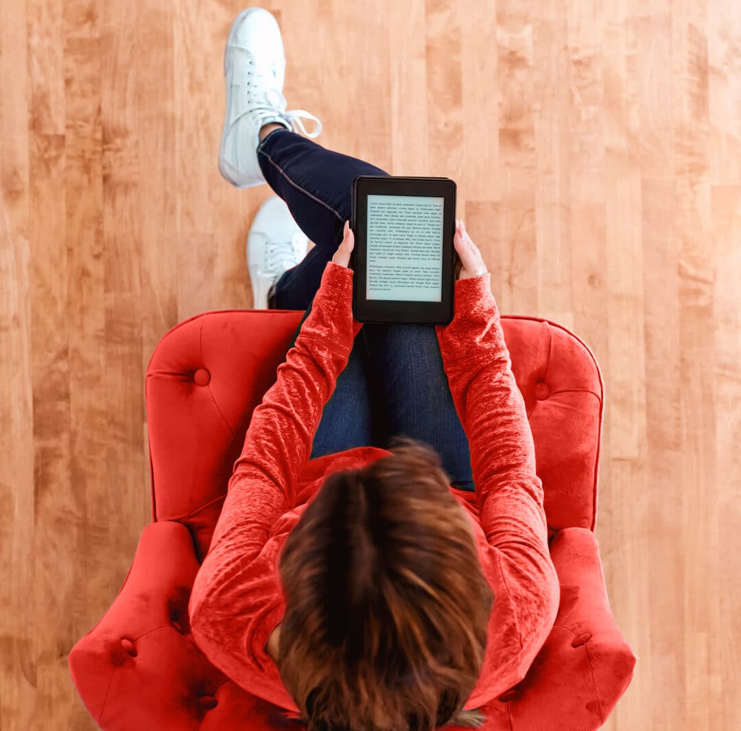 Woman reading a from an e-book tablet