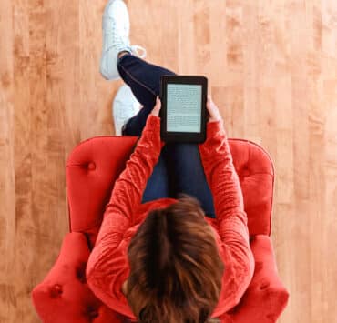 Woman reading a from an e-book tablet