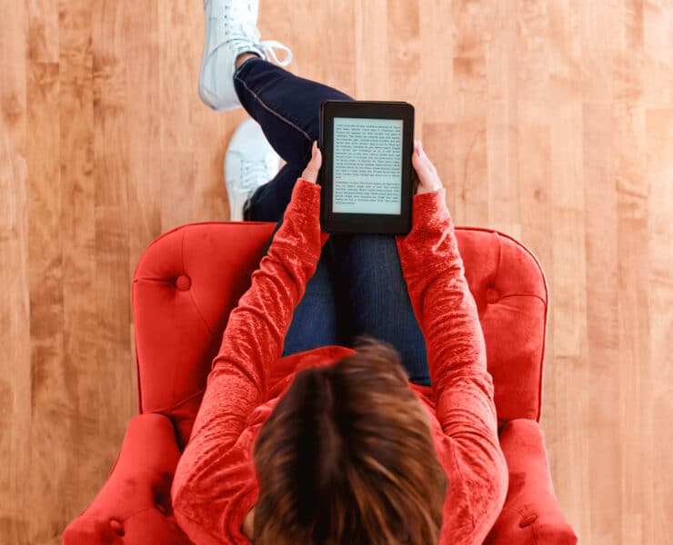 Woman reading a from an e-book tablet