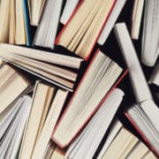 the bottoms/tops of books are shown, closely placed together. spines are not visible, nor covers.