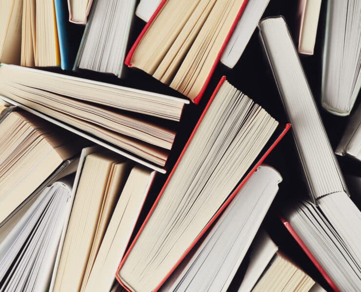 the bottoms/tops of books are shown, closely placed together. spines are not visible, nor covers.