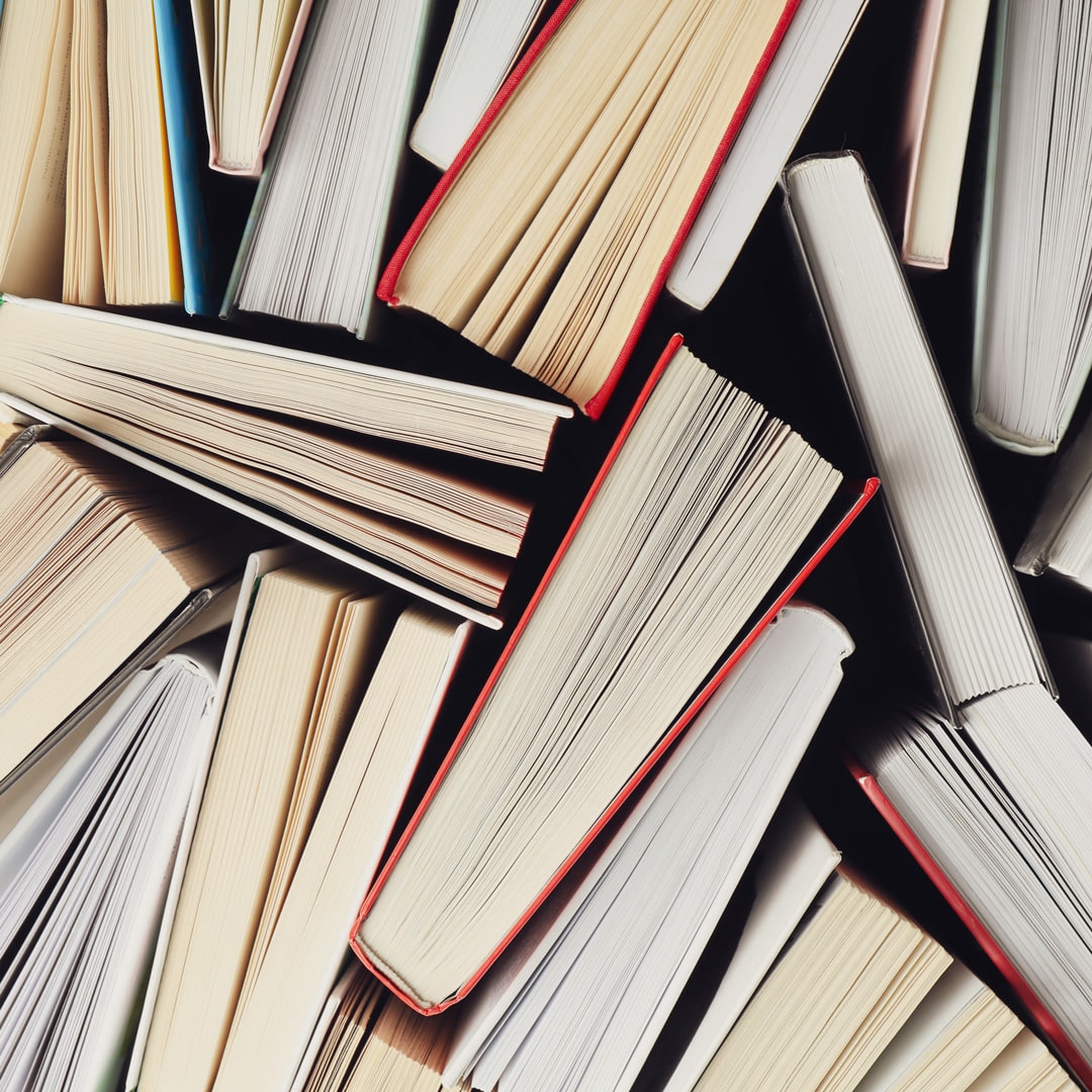 the bottoms/tops of books are shown, closely placed together. spines are not visible, nor covers.