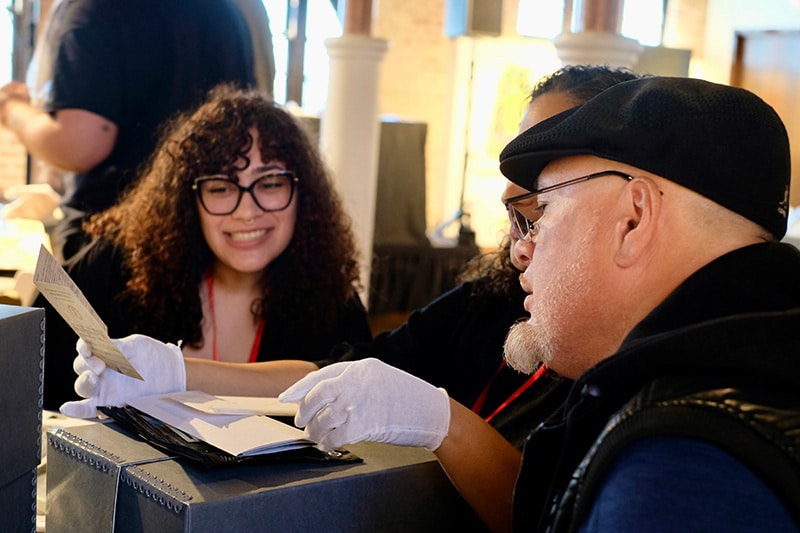 Audience members at the Puerto Rican Archives Symposium learn the proper process for archiving and preserving community memory.